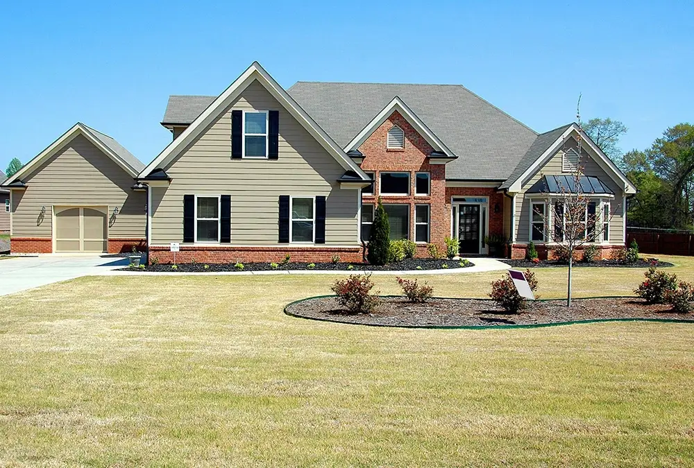 A large house with a lawn in front of it.