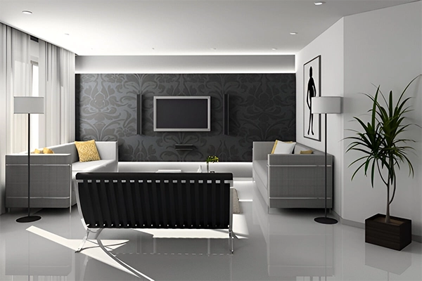 A living room with white walls and black furniture.