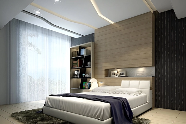 A bedroom with a bed, nightstand and window.