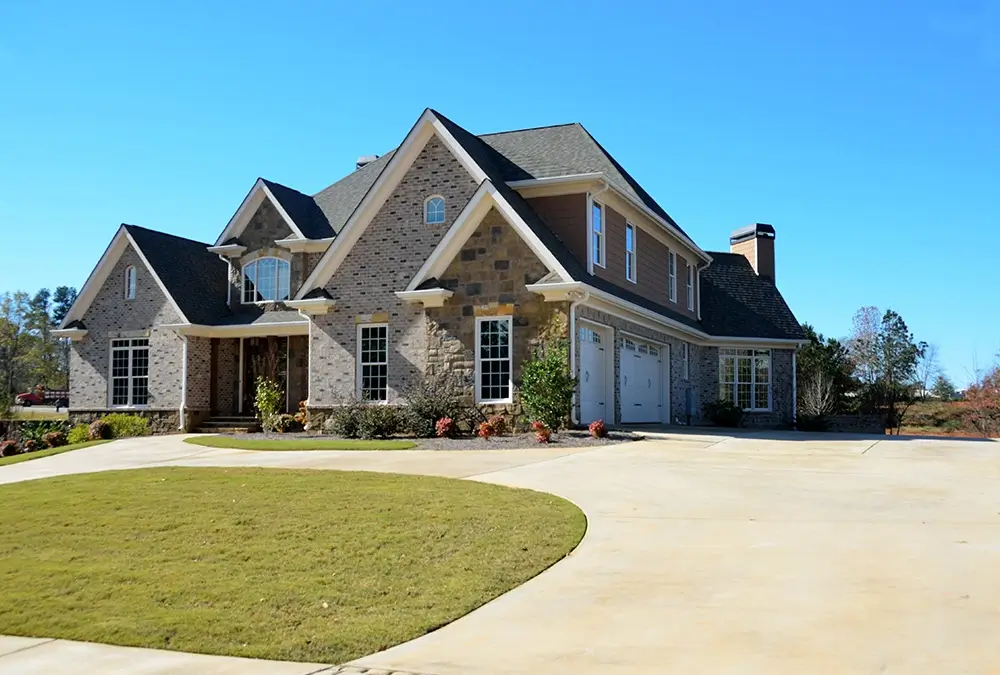 A large house with a lawn in front of it.