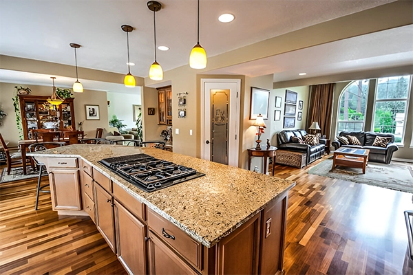 A kitchen with a stove and island in it